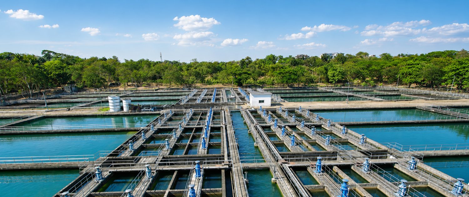 Aerial view of a water treatment facility with sedimentation basins