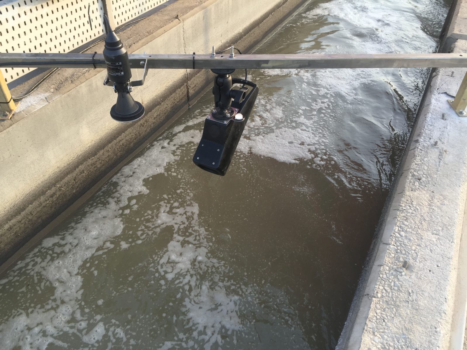 Non-contact radar flowmeter mounted above an open channel